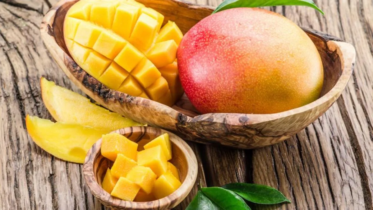 Kent mango cut into cubes in a wooden bowl